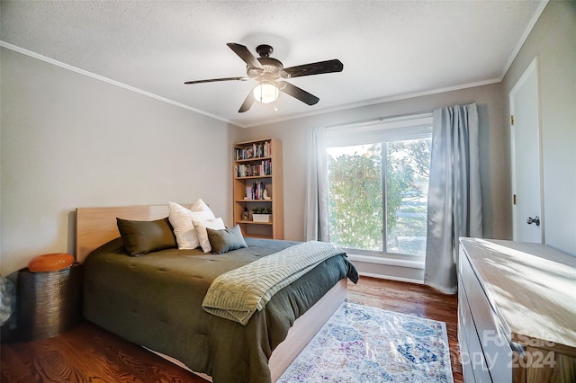 bedroom featuring ornamental molding, dark hardwood / wood-style flooring, a textured ceiling, and ceiling fan