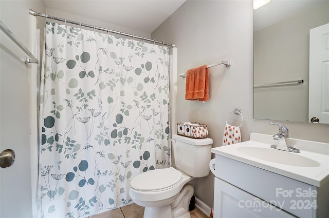 bathroom featuring toilet, curtained shower, vanity, and tile patterned floors