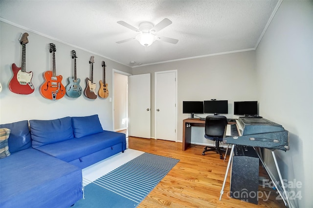 home office featuring ceiling fan, a textured ceiling, hardwood / wood-style flooring, and ornamental molding