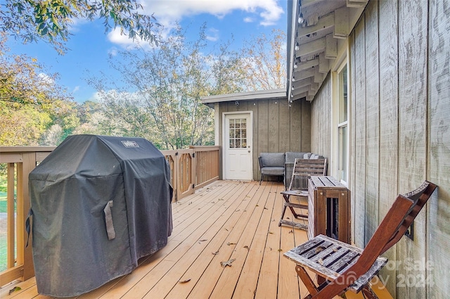 wooden deck featuring a grill