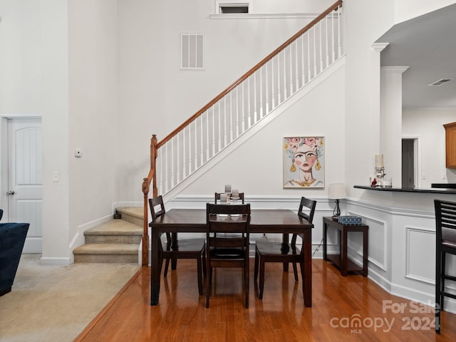 dining area with wood-type flooring and ornamental molding