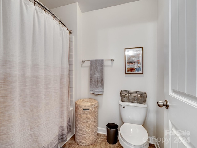 bathroom with tile patterned flooring, curtained shower, and toilet