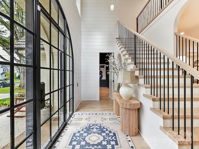 foyer entrance featuring a high ceiling and light wood-type flooring