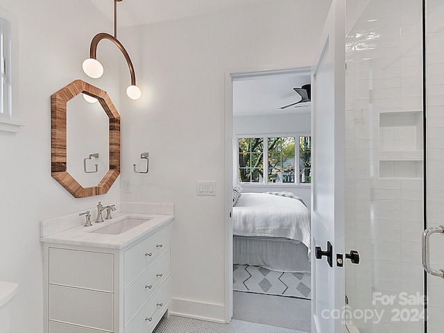 bathroom with walk in shower, ceiling fan, and vanity