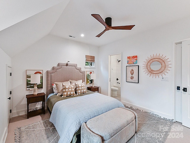 bedroom featuring ceiling fan, connected bathroom, carpet flooring, and vaulted ceiling