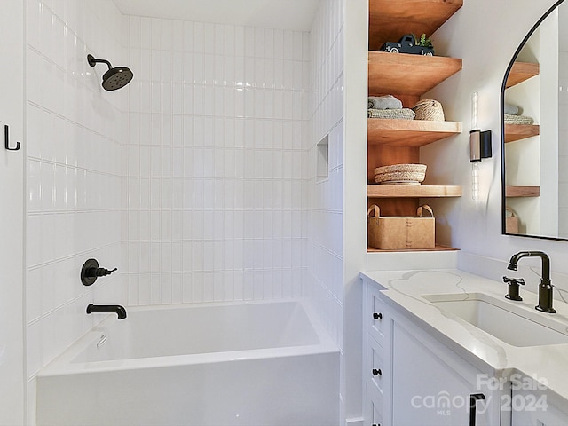 bathroom featuring vanity and tiled shower / bath combo