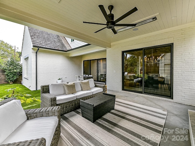 wooden terrace featuring an outdoor living space, a patio, and ceiling fan