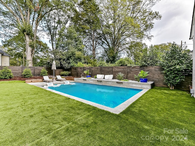 view of pool featuring a lawn