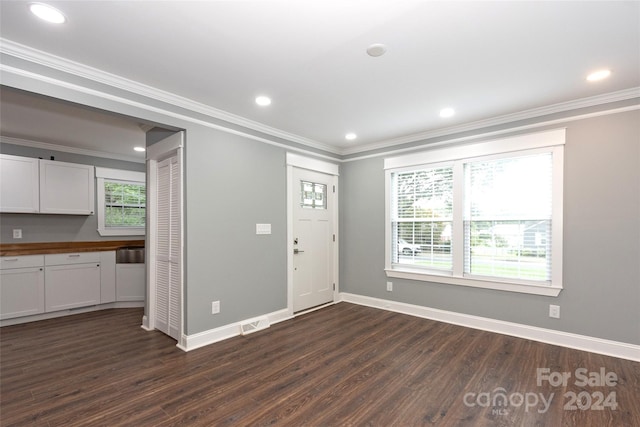 entryway featuring crown molding and dark hardwood / wood-style flooring