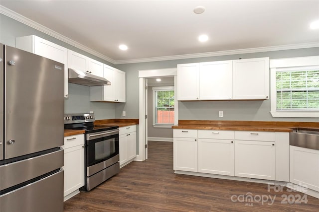 kitchen featuring dark wood-type flooring, butcher block countertops, white cabinetry, and appliances with stainless steel finishes