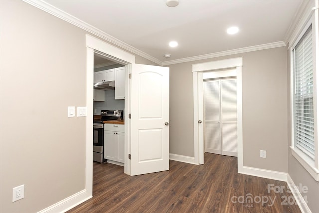 unfurnished bedroom featuring a closet, dark hardwood / wood-style floors, and crown molding