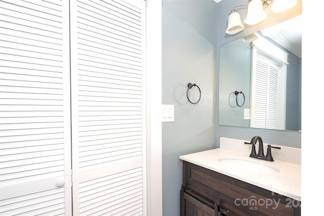 bathroom with vanity and ornamental molding