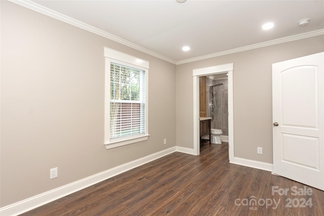 unfurnished bedroom featuring ensuite bath, dark hardwood / wood-style flooring, and crown molding