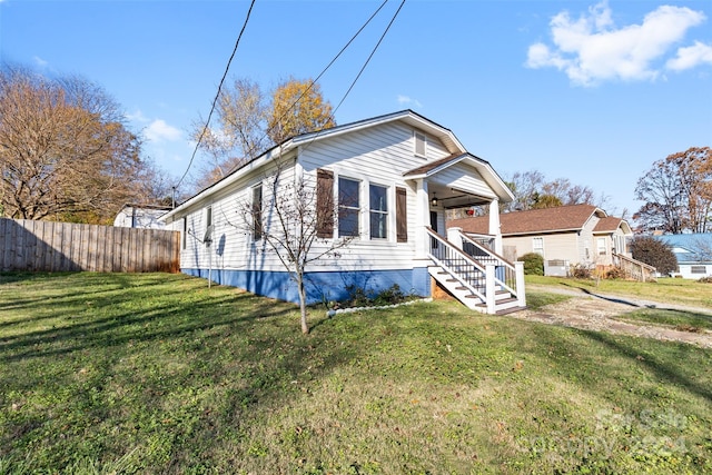 view of front facade with a front yard and covered porch