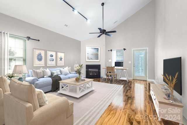 living room with hardwood / wood-style floors, ceiling fan, high vaulted ceiling, and track lighting