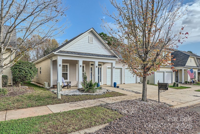 view of front of house with a porch, driveway, and an attached garage