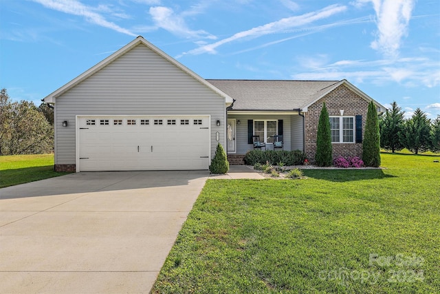 ranch-style home featuring a front yard, a porch, and a garage