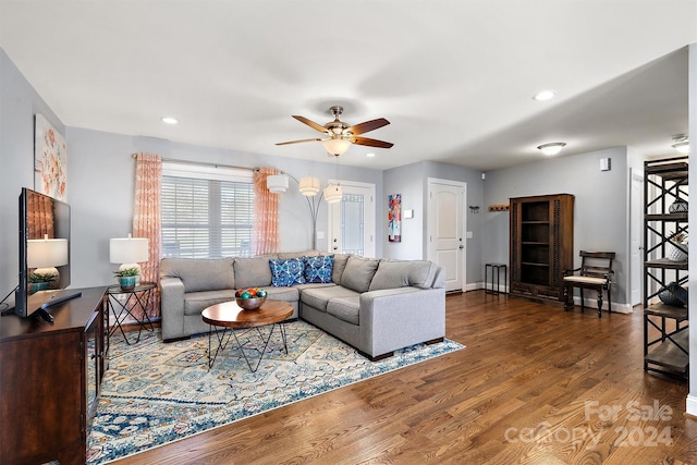 living room with ceiling fan and hardwood / wood-style flooring