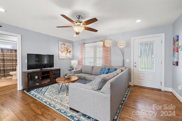 living room with ceiling fan and hardwood / wood-style floors