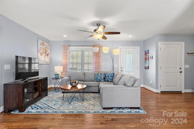 living room with ceiling fan and hardwood / wood-style flooring