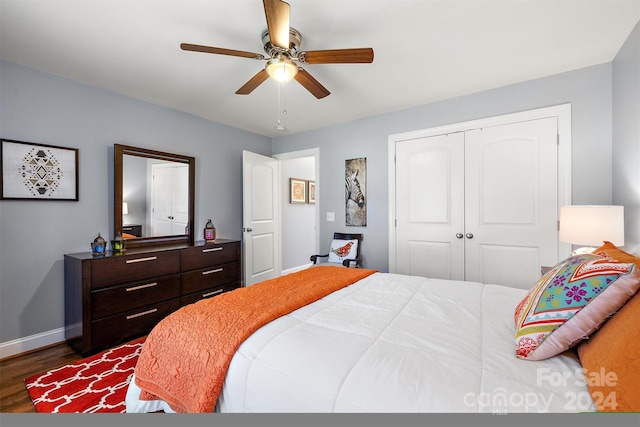 bedroom with a closet, ceiling fan, and dark wood-type flooring