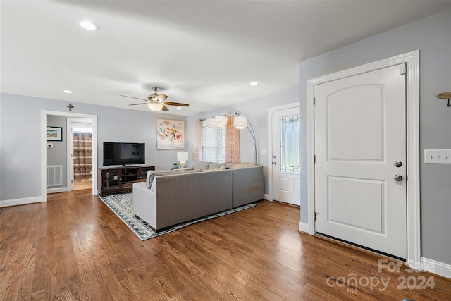 living room with ceiling fan and hardwood / wood-style flooring