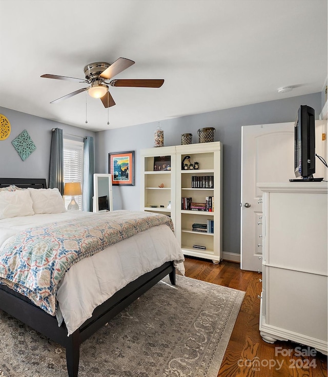 bedroom featuring dark hardwood / wood-style floors and ceiling fan