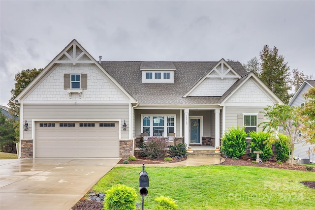 craftsman house with a garage and a front yard