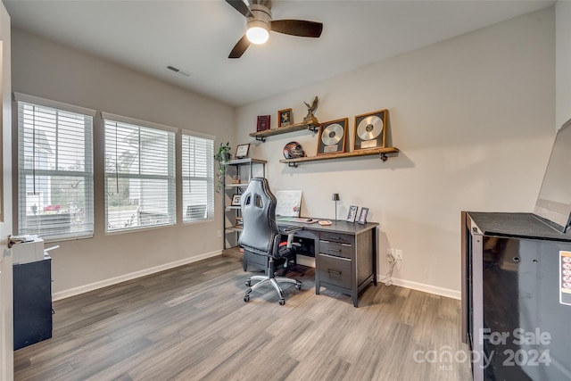 home office featuring ceiling fan and light hardwood / wood-style flooring