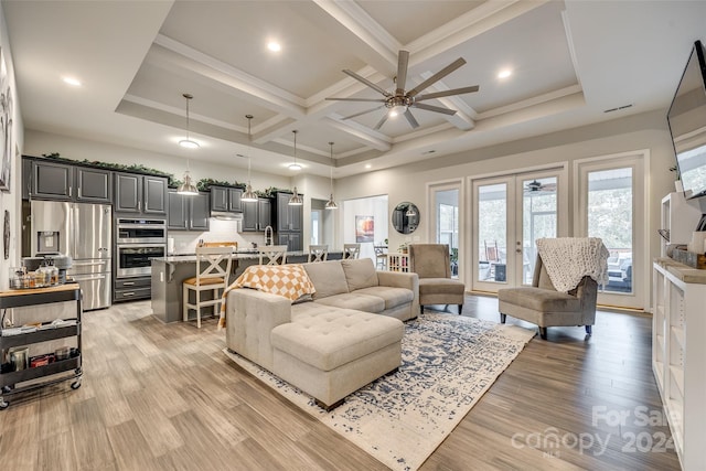 living room featuring beamed ceiling, ceiling fan, coffered ceiling, light wood-type flooring, and french doors