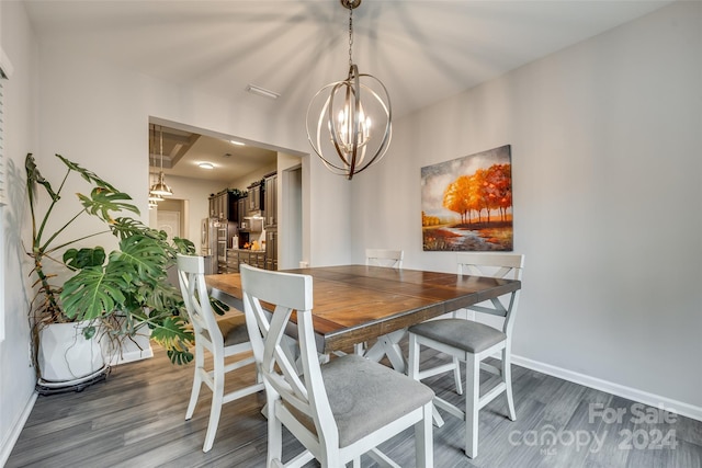 dining space with a chandelier and dark hardwood / wood-style floors