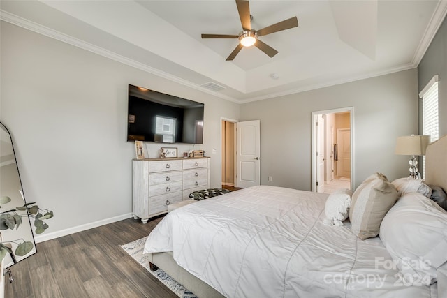 bedroom featuring ensuite bathroom, ceiling fan, a tray ceiling, crown molding, and dark hardwood / wood-style flooring