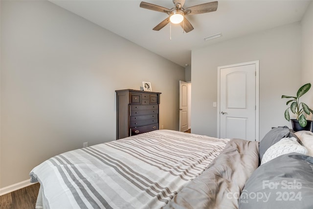 bedroom with dark hardwood / wood-style flooring and ceiling fan