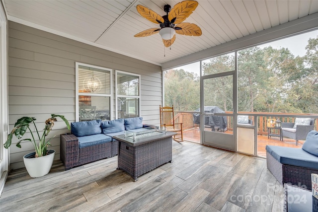 sunroom with wooden ceiling and ceiling fan