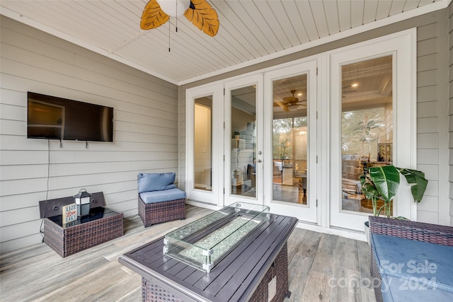 wooden deck featuring french doors and ceiling fan