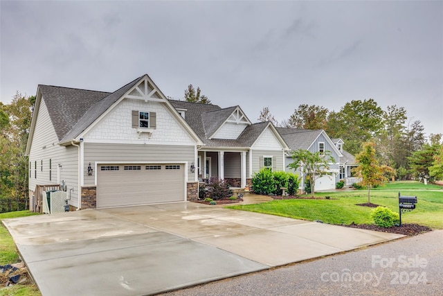 craftsman house with a garage and a front yard