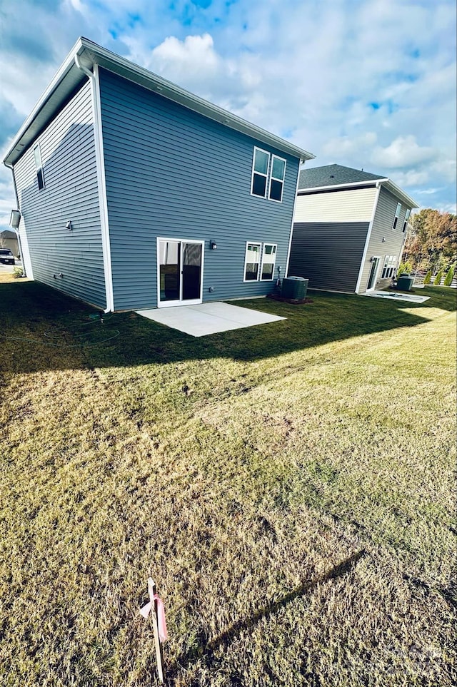 back of house with a patio area and a yard