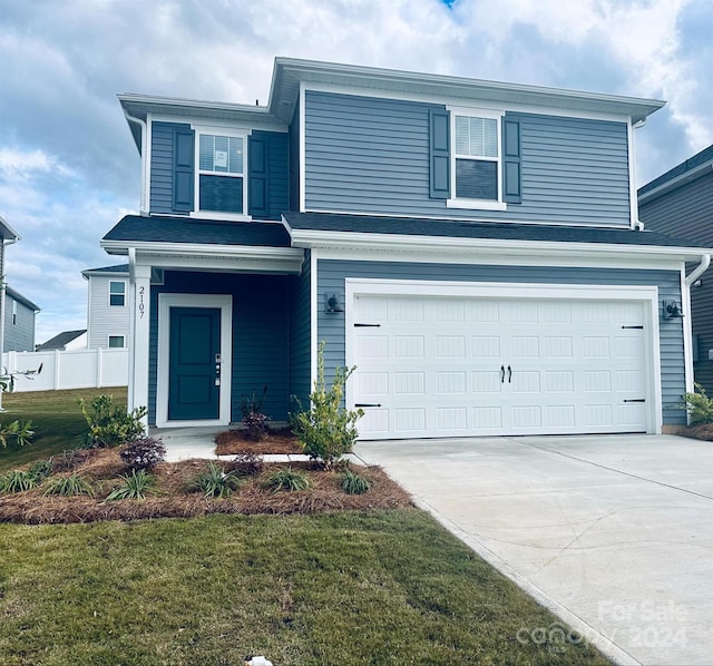 front of property with a front yard and a garage