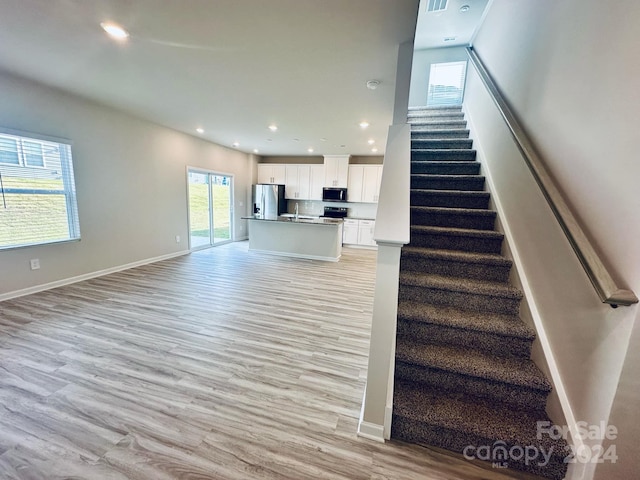 stairway featuring hardwood / wood-style flooring