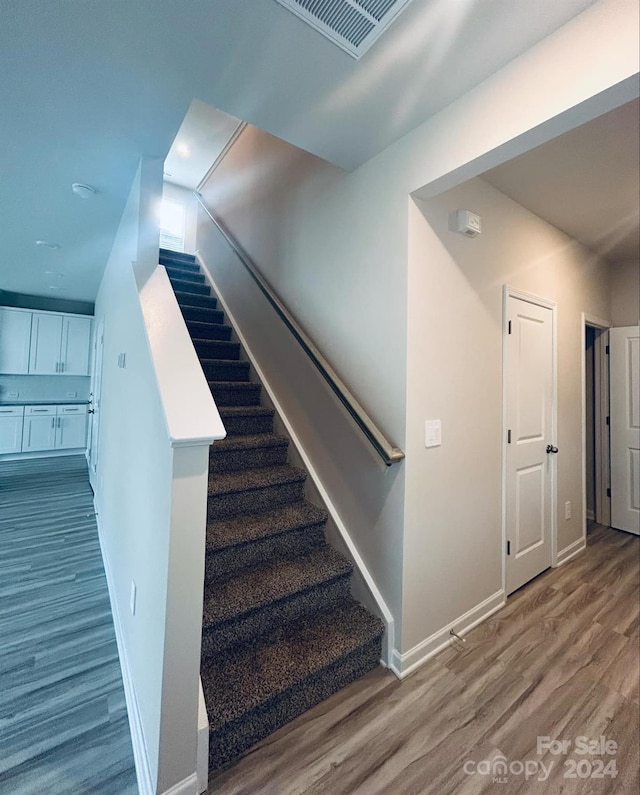 stairway featuring hardwood / wood-style floors