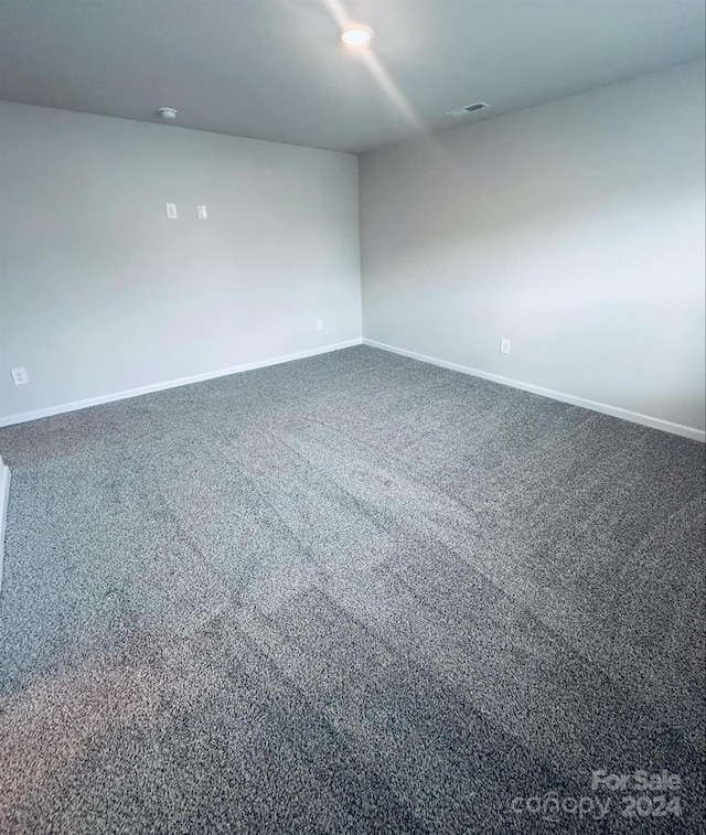 empty room with dark carpet