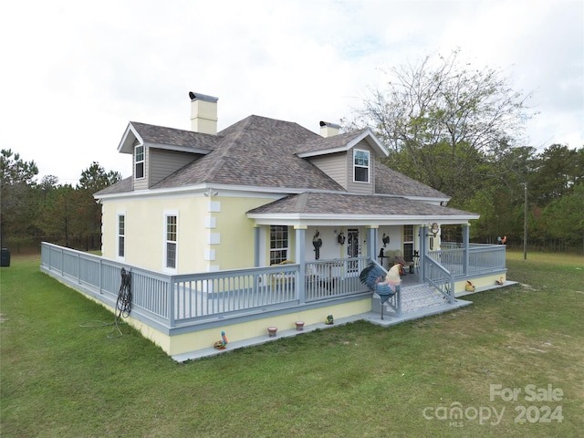 2034 Haileys Ferry Rd, Lilesville, NC 28091 - rear view of house featuring roof with shingles, a porch, a lawn, and a chimney