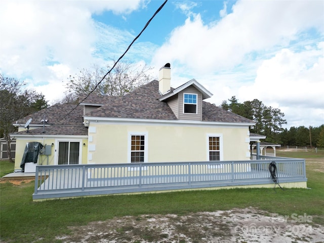 2034 Haileys Ferry Rd, Lilesville, NC 28091 - back of property featuring a shingled roof, stucco siding, a deck, a chimney, and a yard