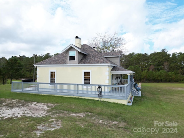 2034 Haileys Ferry Rd, Lilesville, NC 28091 - back of property with roof with shingles, a chimney, a lawn, stucco siding, and a deck