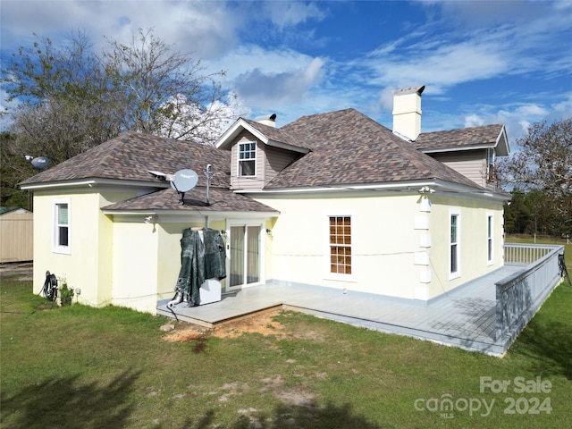 2034 Haileys Ferry Rd, Lilesville, NC 28091 - back of property with a lawn, a chimney, a patio area, stucco siding, and a shingled roof