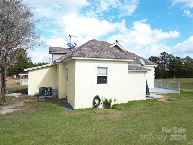 2034 Haileys Ferry Rd, Lilesville, NC 28091 - view of property exterior with roof with shingles, stucco siding, and cooling unit