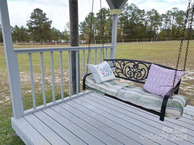 wooden deck featuring a yard