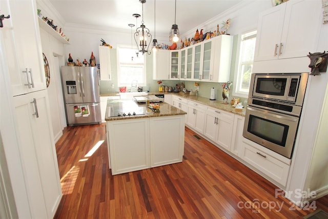 2034 Haileys Ferry Rd, Lilesville, NC 28091 - kitchen with stainless steel appliances, healthy amount of natural light, crown molding, a center island, and glass insert cabinets