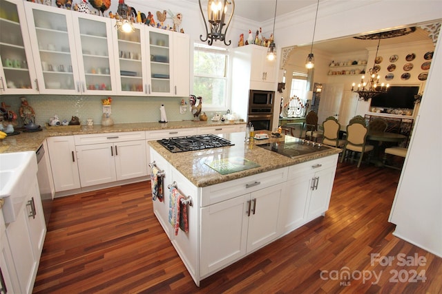 2034 Haileys Ferry Rd, Lilesville, NC 28091 - kitchen with a chandelier, appliances with stainless steel finishes, crown molding, dark wood finished floors, and white cabinetry