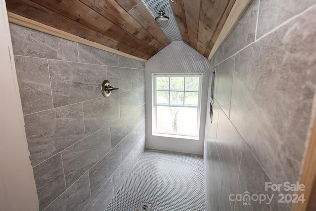 bathroom with a shower, wood ceiling, tile walls, and vaulted ceiling